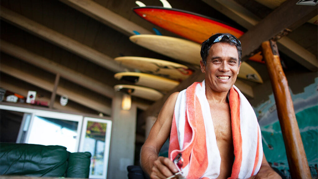 Ho stands on the porch with a warm smile of Aloha. - Brian Bielmann
